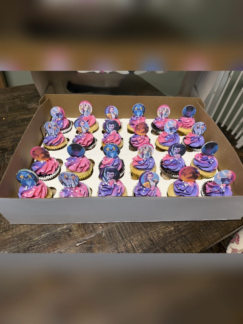 A box of purple, pink, and blue swirled cupcakes