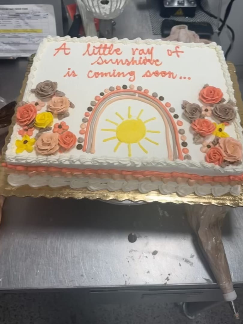 Sheet cake with a smiling rainbow sun and buttercream roses