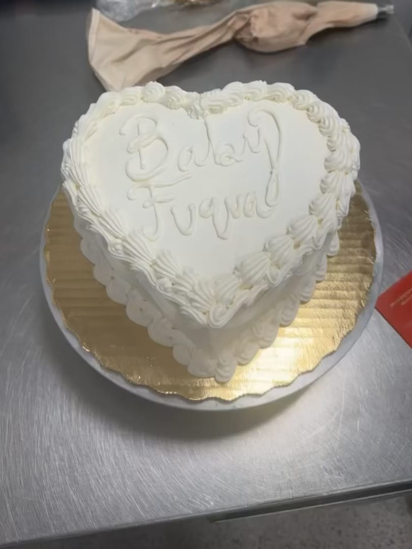 White heart-shaped cake with ruffled piping