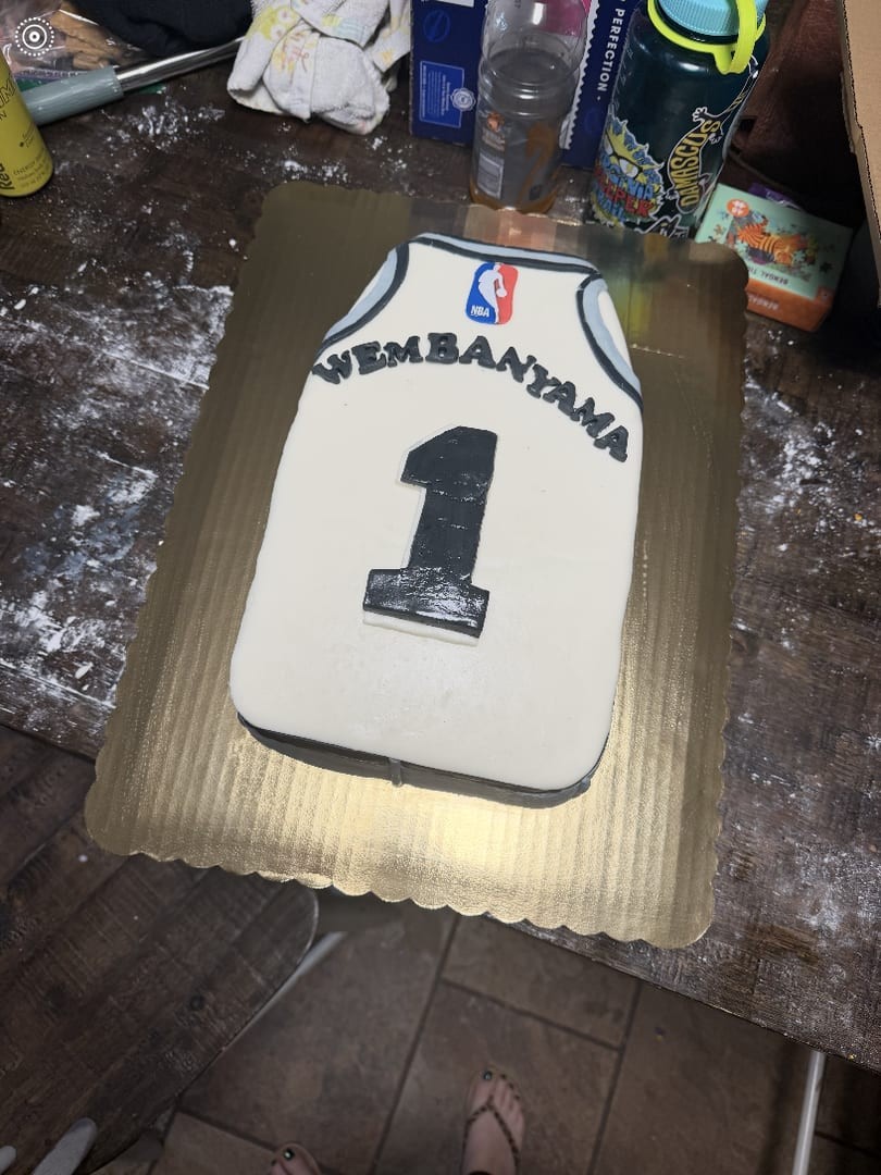 Fondant cake shaped like a basketball jersey with the number 1